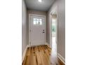 Bright entryway featuring a white front door with glass panel and beautiful hardwood flooring at 2599 Woodcreek Ln., Conway, SC 29527