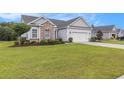 Well-maintained lawn complements this lovely single-story home, showcasing its appealing exterior and curb appeal at 364 Palm Lakes Blvd., Little River, SC 29566
