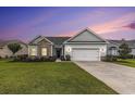 Charming single-story home with a well-manicured lawn, two-car garage, and nicely landscaped garden at 364 Palm Lakes Blvd., Little River, SC 29566
