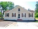 A charming white brick home with brown shutters, offering classic style and curb appeal at 401 S Nichols St., Nichols, SC 29581