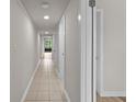 Hallway with tile flooring, neutral paint and doors along each side at 415 Ocean Creek Dr. # 2388, Myrtle Beach, SC 29572