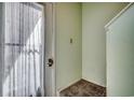 A cozy corner of an entryway featuring a door with a sheer curtain and neutral wall color at 4486 Little River Inn Ln. # 2106, Little River, SC 29566