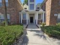 Welcoming entryway with meticulously maintained landscaping, leading to a beautifully designed condo at 45 Woodhaven Dr. # D, Murrells Inlet, SC 29576