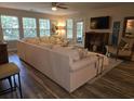 Cozy living room with a plush sectional sofa, ceiling fan, and ample natural light at 45 Woodhaven Dr. # D, Murrells Inlet, SC 29576