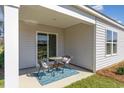 Cozy covered patio with outdoor seating, ideal for relaxing or entertaining guests with views of the backyard at 501 Sagebrush St., Myrtle Beach, SC 29588