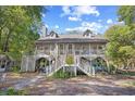 Spacious two-story home featuring a large screened porch and inviting entry stairs at 515 River Rd., Conway, SC 29526