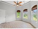 Bright bedroom features wood floors, large windows and trim, and ceiling fan at 528 Chamberlin Rd., Myrtle Beach, SC 29588