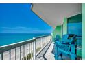 Open-air balcony with Adirondack chairs, offering stunning views of the shoreline and ocean at 5310 N Ocean Blvd. # 10B, North Myrtle Beach, SC 29582
