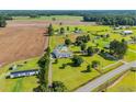 Aerial view of a charming home, surrounded by a verdant lawn and expansive farmland, offering a serene country lifestyle at 5589 Highway 668, Conway, SC 29526