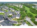 Aerial view of condo building nestled within a community featuring lush landscaping and golf course at 5801 Oyster Catcher Dr. # 332, North Myrtle Beach, SC 29582