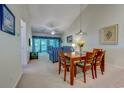 Open-concept living room with vaulted ceiling, adjacent dining area, and balcony access at 601 N Hillside Dr. # 4434, North Myrtle Beach, SC 29582