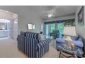 Cozy living room with vaulted ceiling, ceiling fan, balcony access and views of a wooded area at 601 N Hillside Dr. # 4434, North Myrtle Beach, SC 29582