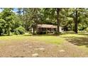 Cozy single-story home surrounded by lush greenery, offering a peaceful and private setting at 6805 Mclaurin Rd., Mullins, SC 29574
