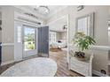 Elegant foyer with a stylish rug, showcasing a view into the bedroom and a bright entrance with natural light at 7005 Wellesley Ct., Murrells Inlet, SC 29576