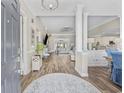 Inviting living room with hardwood floors, featuring elegant columns, neutral décor, and an open layout to the dining area at 7005 Wellesley Ct., Murrells Inlet, SC 29576