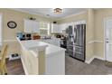 Bright kitchen featuring stainless steel appliances, white cabinets, and a breakfast bar at 701 Salleyport Dr. # 1110, Myrtle Beach, SC 29579
