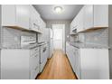 Galley kitchen with white cabinets, appliances, and grey countertops at 755 Burcale Rd. # E-3, Myrtle Beach, SC 29579