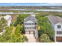 Stunning aerial view of a two-story home, showcasing its proximity to the waterway, and scenic surroundings at 92 High Hammock Way, Pawleys Island, SC 29585