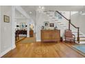 Inviting foyer boasts hardwood floors with compass design, complemented by elegant furnishings and a staircase at 92 High Hammock Way, Pawleys Island, SC 29585