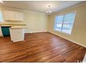 Cozy dining area featuring hardwood flooring, a chandelier, and a large window offering natural light at 1000 Weldon Ln., Conway, SC 29526