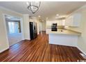 Open concept kitchen featuring stainless steel appliances, hardwood flooring, and a breakfast bar at 1000 Weldon Ln., Conway, SC 29526