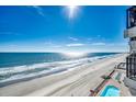 Beautiful beach view and oceanfront pool from the balcony with lounge chairs available for relaxing at 1210 N Waccamaw Dr. # 602, Murrells Inlet, SC 29576