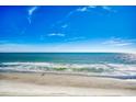Beautiful beach view with blue sky with fluffy clouds and sunlight reflecting off the water at 1210 N Waccamaw Dr. # 602, Murrells Inlet, SC 29576