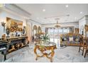 A luxurious living room boasts a marble floor, high ceilings with gold trim, and an elegant sitting area with ocean views at 123 Pioneer Loop, Georgetown, SC 29440