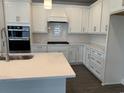Modern kitchen with white cabinets, quartz countertops, stainless steel appliances, and a subway tile backsplash at 1436 Winding Creek Way, Myrtle Beach, SC 29588