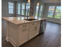 Kitchen island featuring a sink, stainless steel dishwasher, quartz countertop, and pendant lighting at 1436 Winding Creek Way, Myrtle Beach, SC 29588