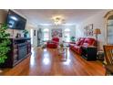 Spacious living room with hardwood floors, comfortable seating, and bright windows at 1437 Baldwin Ct. # 1437, Little River, SC 29566