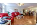 Cozy living room with hardwood floors, bright light, and adjacent dining area at 1437 Baldwin Ct. # 1437, Little River, SC 29566