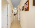 Long hallway featuring beige walls, tile flooring, and framed portraits at 1505 Lantern Rest Dr. # 301, Myrtle Beach, SC 29579