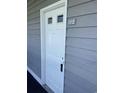 Exterior of the condominium showing the entrance to unit 112 with gray siding at 1509 N Waccamaw Dr. # 112, Murrells Inlet, SC 29576