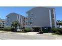 Exterior shot of a condominium building with covered parking at 1509 N Waccamaw Dr. # 112, Murrells Inlet, SC 29576
