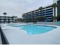 A large swimming pool with palm trees, sun loungers, and a high-rise building at 1600 S Ocean Blvd. S # 150, Myrtle Beach, SC 29577