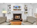 Cozy fireplace with black tile surround, flanked by custom built-in shelving and hardwood floors at 179 Golden Bear Dr. # C4, Pawleys Island, SC 29585