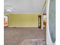 Open-concept living room is enhanced by neutral carpet, ceiling fan, and an open view of the dining room at 203 Warbler St., Georgetown, SC 29440
