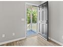 Interior shot of a front door with the house number 204, opening to a covered porch at 204 Elm St., Johnsonville, SC 29555
