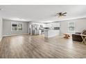 Open concept living area featuring modern flooring, gray walls, stainless appliances, and a breakfast bar at 204 Elm St., Johnsonville, SC 29555