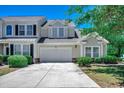 Charming exterior features a two-car garage, fresh paint, and beautiful greenery at 205 Threshing Way # 1052, Myrtle Beach, SC 29579
