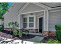 Charming front porch with stylish black door, stone accents, and fresh landscaping at 205 Threshing Way # 1052, Myrtle Beach, SC 29579
