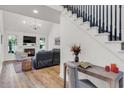 Bright living room featuring fireplace, vaulted ceiling, and staircase with dark railings at 2150 North Berwick Dr., Myrtle Beach, SC 29575
