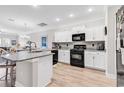 Modern kitchen featuring white cabinets, granite countertops, stainless appliances, and a center island with seating at 232 Je Edward Dr. # 19, Myrtle Beach, SC 29588