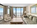 Bright living room with balcony access showcasing stunning ocean views at 2500 N Ocean Blvd. # 601, Myrtle Beach, SC 29577