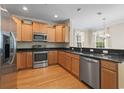 Well-equipped kitchen featuring stainless steel appliances, wooden cabinets, and granite countertops at 278 Carolina Crossing Blvd., Little River, SC 29566
