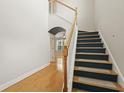 Bright foyer featuring hardwood floors and a staircase with wooden handrail and carpeted treads at 278 Carolina Crossing Blvd., Little River, SC 29566