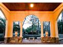 Picturesque arched veranda with decorative stone accents and views of the serene landscape, blending indoor and outdoor living at 2790 Fowler Rd., Loris, SC 29569