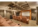 Private home theater with plush seating, a large screen, and coffered ceiling, perfect for immersive entertainment at 2790 Fowler Rd., Loris, SC 29569