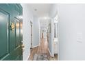 Bright hallway with light blue walls, wood floors, and a view into other rooms, creating a welcoming space at 3104 Sweetwater Blvd. # 3104, Murrells Inlet, SC 29576